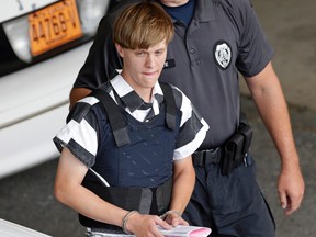 In this June 18, 2015 file photo, Charleston, S.C., shooting suspect Dylann Storm Roof is escorted from the Cleveland County Courthouse in Shelby, N.C. (AP Photo/Chuck Burton, File)