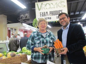 Nell Vrolyk, left, with Vrolyk's Farm Produce, and Dr. Sudit Ranada, Lambton County's medical officer of health, hold up some of the farm's produce at the Sarnia Farmers' Market at the announcement of recommendations by a community assessment food task force on Wednesday December 14, 2016 in Sarnia, Ont. 
Paul Morden/Sarnia Observer/Postmedia Network