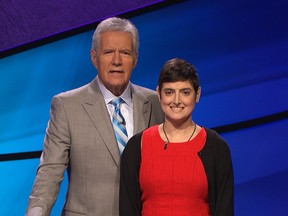 In this Aug. 31, 2016 photo provided by Jeopardy Productions, Inc., Cindy Stowell, right, appears on the "Jeopardy!" set with Alex Trebek in Culver City, Calif. Stowell, who competed on "Jeopardy!" while battling terminal colon cancer has died the week before her episode was set to air on Tuesday, Dec. 13, but prize money has gone to cancer research as she wished. (Courtesy of Jeopardy Productions, Inc. via AP)