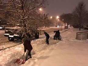 Daniel Medina's two boys shovel snow for a neighbour (Facebook)