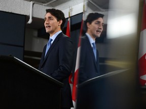 Prime Minister Justin Trudeau is reflected in a TV monitor as he holds a press conference at the National Press Theatre in Ottawa on Monday, Dec. 12, 2016. (THE CANADIAN PRESS/Sean Kilpatrick)