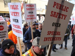 Trades workers march into the Lasalle Mews to meet with Kingston and the Islands MPP Sophie Kiwala during a protest against Bill 70 in Kingston, Ont. on Friday, Dec. 9, 2016. 
Elliot Ferguson/The Whig-Standard/Postmedia Network