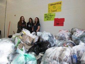 Carrie Champagne, Grade 12, Grace Van Eerd, Grade 12, and Emily Cyr, Grade 10, stand Wednesday with 71 bags of garbage collected at Great Lakes Secondary School over a 24-hour period. The members of the school's environment club were hoping to inspire people at the school to think about how to reduce the amount of garbage they produce. (Tyler Kula/Sarnia Observer)