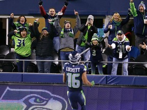 Seahawks fans cheer Tyler Lockett on his touchdown against the Panthers early in the second half of an NFL game in Seattle on Dec. 4, 2016. (Stephen Brashear/AP Photo)
