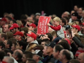 Supporters of President-Elect Donald Trump listen as he speaks at a Thank You Tour 2016 rally on December 13, 2016 in West Allis, Wisconsin. Trump and his running mate Mike Pence have been holding the rallies in several states recently to thank voters for electing them. (Photo by Scott Olson/Getty Images)