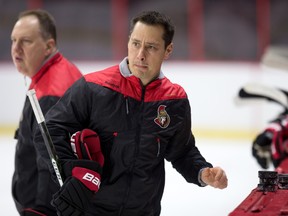 Senators assistant coach Martin Raymond (left) and head coach Guy Boucher watch a play as the team practises at Canadian Tire Centre last month. (Wayne Cuddington/Postmedia)