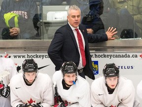 Team Canada's head coach Dominique Ducharme watches the play against the Czech Republic during the third period of a world junior exhibition game in Boisbriand, Que., on Wednesday, Dec. 14, 2016. (Ryan Remiorz/The Canadian Press)