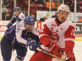 Sudbury Wolves defenceman Zack Wilkie gets a stick on Soo Greyhounds' Boris Katchouk during OHL action at Essar Centre in Sault Ste. Marie on Wednesday night. Mike Verdone/Postmedia Network