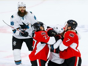 Ottawa Senators right wing Curtis Lazar (27) and Kyle Turris (7) go after San Jose Sharks defenceman Marc-Edouard Vlasic (44) after he hit Sens captain Erik Karlsson (not pictured) in the face with his stick during NHL action at the Canadian Tire Centre on Wednesday December 14, 2016. Errol McGihon/Postmedia