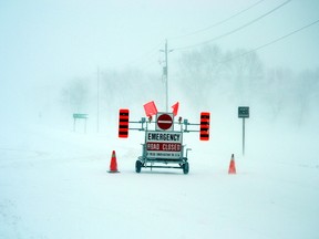 A snow squall hovering over Perth County Dec. 15 resulted in school being cancelled, Highways and county roads being being closed and near whiteout conditions. Pictured, a road closure sign at the east end of Mitchell informs drivers that Highway 8 between Mitchell and Stratford is closed. GALEN SIMMONS MITCHELL ADVOCATE