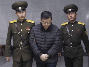 Hyeon Soo Lim, who pastors the Light Korean Presbyterian Church in Toronto, is escorted to his sentencing in Pyongyang, North Korea, on Dec. 16, 2015. (THE CANADIAN PRESS/AP/Jon Chol Jin)