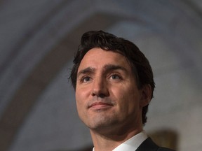 Prime Minister Justin Trudeau listens to a question as he speaks with the media after meeting with Assembly of First Nations Chief Perry Bellegarde, President of the Inuit Tapiriit Kanatami Natan Obed and Manitoba Metis President David Chartrand in the foyer of the House of Commons on Parliament Hill in Ottawa, Thursday, December 15, 2016. (THE CANADIAN PRESS/Adrian Wyld)