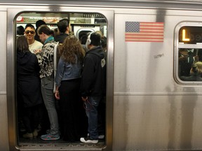 This May 5, 2016 file photo shows passengers crowd on the L Train subway in the Brooklyn borough of New York. (AP Photo/William Mathis, File)