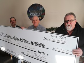 Jason Miller/The Intelligencer
Richard Hanson, (centre) chairperson of the Children's Safety Village, collects a $5,000 donation from Jason Sparaga, CEO of Spark Power Corp. (first left) and  Arnold Portt, (right) of Taltrees Power Services.