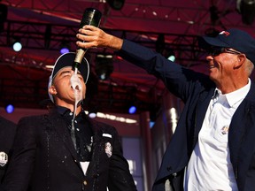 Vice-captain Tom Lehman pours champagne on Rickie Fowler during the closing ceremony of the 2016 Ryder Cup at Hazeltine National Golf Club in Chaska, Minn., on Oct. 2, 2016. (Ross Kinnaird/Getty Images)