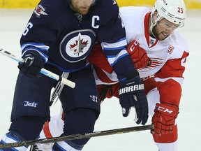 Winnipeg Jets right winger Blake Wheeler (left) and Detroit Red Wings defenceman Mike Green tangle during a game last week. (Brian Donogh/Winnipeg Sun file photo)