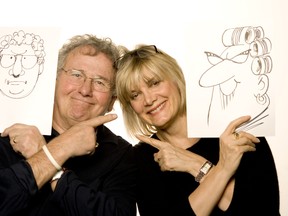 Sun cartoonists Andy Donato and Sue Dewar pose with cartoons of themselves in this file photo. (Postmedia Network files)