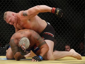 Brock Lesnar (top) fights Mark Hunt during their heavyweight bout at UFC 200 in Las Vegas on July 9, 2016. (John Locher/AP Photo/Files)