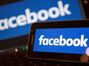 This file photo taken on November 21, 2016 shows Facebook logos pictured on the screens of a smartphone (R), and a laptop computer, in central London.
(JUSTIN TALLIS/AFP/Getty Images)