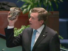 Mayor John Tory holds up a piece of the Gardiner during a city council meeting on Dec. 15. (HANDOUT, Postmedia Network)