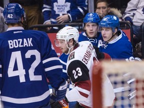 Toronto Maple Leafs centre Mitchell Marner (right) celebrates his goal with teammate Matt Hunwick as Arizona Coyotes defenceman Oliver Ekman-Larsson (23) and Maple Leafs' Tyler Bozak skate by during second period NHL hockey action in Toronto, on Thursday December 15, 2016.THE CANADIAN PRESS/Chris Young