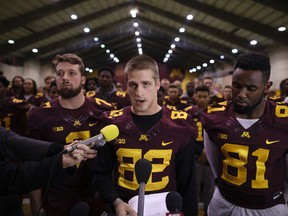 University of Minnesota wide receiver Drew Wolitarsky stands in front of team members as he reads a statement on behalf of the players in the Nagurski Football Complex in Minneapolis, Minn., on Dec. 15, 2016. (Jeff Wheeler/Star Tribune via AP)