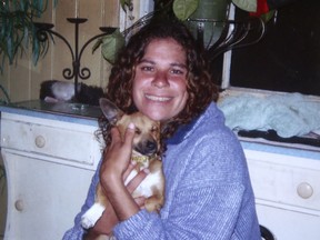 This 2010 photo released by the Daley family shows Lynette Daley cuddling her dog, Bunyip, in Australia. The brutal death of Daley, an Aboriginal woman, and the reluctance of officials to prosecute the white suspects, has highlighted a deadly racial divide in Australia, where Indigenous people remain the most disadvantaged segment of society. (Daley family via AP Photo)