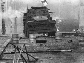 In this April 17, 1972 file photo, a British Army armoured vehicle makes its way along a barricade while on patrol in the Lower Falls area of west Belfast. (AP Photo/Michel Lipchitz, File)