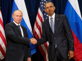 In this Sept. 28, 2015 file photo, U.S. President Barack Obama, right, and Russia's President President Vladimir Putin pose for members of the media before a bilateral meeting at the United Nations headquarters. (AP Photo/Andrew Harnik)