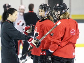From left, Team Canada head coach Laura Schuler and forwards Rebecca Johnston and Jennifer Wakefield discuss a play during practice at Progressive Auto Sales Arena on Wednesday December 14, 2016 in Sarnia, Ont. Canada will face Team USA in the finale of a two-game exhibition series Monday at 7 p.m. in Sarnia. Terry Bridge/Sarnia Observer/Postmedia Network