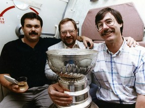 Edmonton Journal sports writers Cam Cole, with Jim Matheson (holding Stanley Cup) and Ray Turchansky.