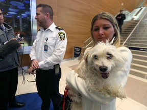 Leland Gordon, chief operating officer of Animal Services in Winnipeg, speaks with media as Terra McCabe from Vancouver is reunited with her dog Daisy at Winnipeg James Armstrong Richardson International Airport on Fri., Dec. 16, 2016. Kevin King/Winnipeg Sun/Postmedia Network
