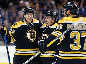 Boston Bruins' David Pastrnak (88), of the Czech Republic, celebrates his second goal of the second period with teammates Brad Marchand, center, and Patrice Bergeron (37) during an NHL hockey game against the Colorado Avalanche in Boston, Thursday, Dec. 8, 2016. (AP Photo/Michael Dwyer)