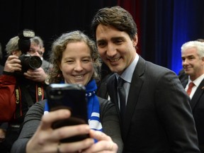 A person takes a selfie with Prime Minister Justin Trudeau as he attends a infrastructure announcement in Montreal, Friday December 16, 2016. (THE CANADIAN PRESS/Ryan Remiorz)
