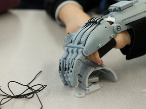 Edmonton students use 3D printers to make hands for children overseas. (Ian Kucerak/Postmedia)