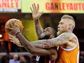 Miami Heat's Willie Reed, left, is fouled by Cleveland Cavaliers' Chris Andersen in the second half of an NBA basketball game Friday, Dec. 9, 2016, in Cleveland. (AP Photo/Tony Dejak)