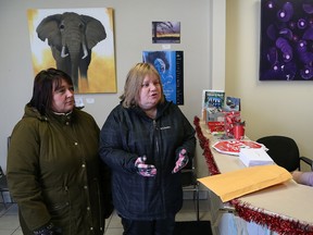 Gisele Dawson, left, president of CUPE Local 2841 representing laundry workers, and Sharon Richer, of the Ontario Council of Hospital Unions, speak to Brian Band, executive assistant at Sudbury MPP Glenn Thibeault's office in Sudbury, Ont. on Friday December 16, 2016. They delivered Christmas cards with letters from the laundry workers explaining the impact of losing their jobs. John Lappa/Sudbury Star/Postmedia Network