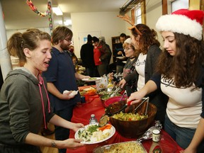 Marymount Academy students Emily Sportan, back right, Mckenzie Lalonde and Victoria Muscolino serve food to Billie Haryett, left, and Cody Lavallee at a Christmas luncheon at the Sudbury Action Centre for Youth in Sudbury on Friday. The luncheon was organized by Grade 12 students at Marymount, and the event has been going on for 27 years. John Lappa/Sudbury Star