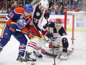 Columbus Blue Jackets goalie Sergei Bobrovsky makes the save as Edmonton Oilers forward Ryan Nugent-Hopkins (93) and David Savard (58) battle for the rebound during second period at Rogers Place on Tuesday December 13, 2016.