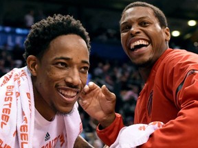 Toronto Raptors guard DeMar DeRozan and Toronto Raptors guard Kyle Lowry ham it up at courtside during the dying moments of second half NBA basketball action against the Atlanta Hawks, in Toronto on Saturday, December 3, 2016. (THE CANADIAN PRESS/Frank Gunn)