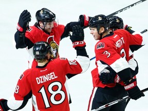Bobby Ryan (top) celebrates a goal against the New Jersey Devils on Dec. 17 at the Canadian Tire Centre. (The Canadian Press)
