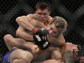 Mickey Gall, rear, applies a choke hold to Sage Northcutt during the second round of a UFC Fight Night mixed martial arts bout in Sacramento, Calif., Saturday, Dec. 17, 2016. Gall won by submission in the second round. (AP Photo/Jeff Chiu)