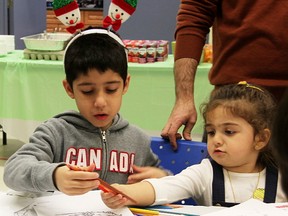 Adam Alkutki, 6, and Ara Nanakly, 3, colour while attending the YMCA Newcomer Winter Festival Saturday in Sarnia. About 80 people attended the event at the YMCA Learning & Career Centre. Tyler Kula/Sarnia Observer/Postmedia Network