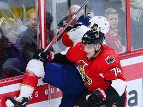 Florida Panthers' Derek MacKenzie gets sent into the boards by Ottawa Senators' Mark Borowiecki during an NHL game in Ottawa on Dec. 3, 2016. (THE CANADIAN PRESS/Sean Kilpatrick)