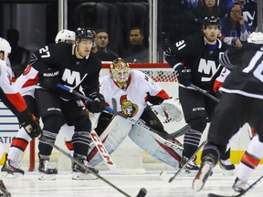 Mike Condon of the Ottawa Senators tends net against the New York Islanders during an NHL game in New York on Dec. 18, 2016. (Bruce Bennett/Getty Images)