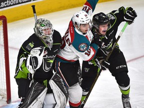 Oil Kings goalie Patrick Dea and defenceman Will Warm sandwich Kelowna Rockets Nick Merkley during the third period of Sunday's game at Rogers Place. (Ed Kaiser)