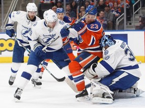 Matt Hendricks, seen here tangling with Lightning defence in front of goalie Ben Bishop, had a good game against Tampa Bay on Saturday. (The Canadian Press)