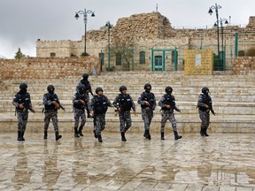 Jordanian security forces patrol in front of Karak Castle in the central town of Karak, about 140 kilometers (87 miles) south of the capital Amman, in Jordan Monday, Dec. 19, 2016. Gunmen assaulted Jordanian police in a series of attacks Sunday, including at the Karak Crusader castle popular with tourists, killing seven officers, two local civilians and a woman visiting from Canada, officials said. (AP Photo/Ben Curtis)