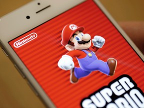 The title screen of Nintendo Co.'s "Super Mario Run" mobile game is displayed on an iPhone screen in this arranged photograph in Tokyo on Dec. 19, 2016. (Bloomberg photo by Takaaki Iwabu)