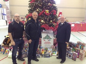 Ward Gordon and Moe Sabourin of the Winnipeg Police Association present 150 toys to Mark Young, executive director, Salvation Army – Toy Mountain campaign. (HANDOUT)